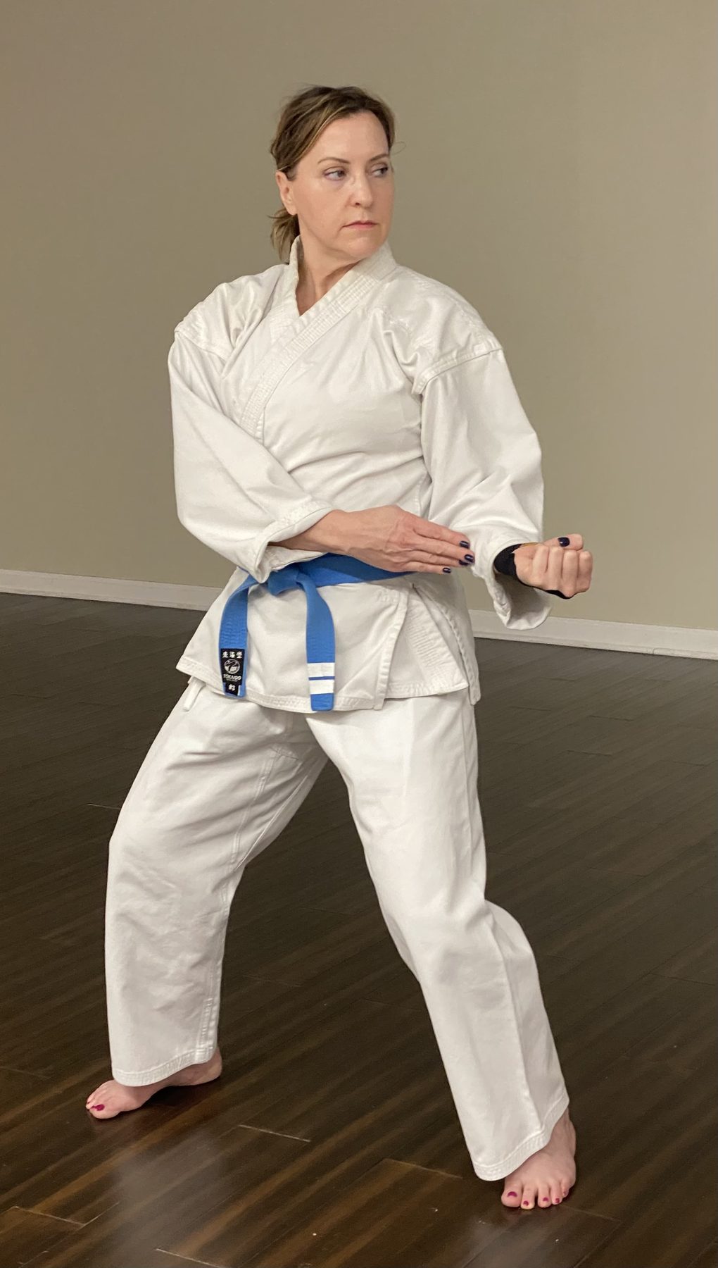 Adult student holding a stance in Korean Karate class